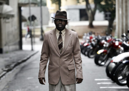 Carlos, a security guard hired by local merchants to curb the presence of crack users who scare off street customers.