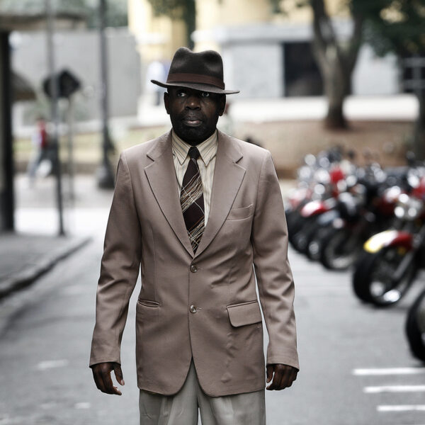 Carlos, a security guard hired by local merchants to curb the presence of crack users who scare off street customers.