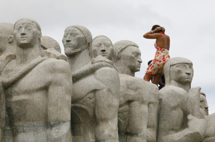 O Monumento - woman scales tourist monument in downtown Sao Paulo