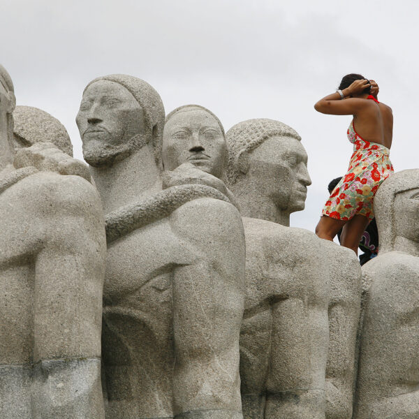 O Monumento - woman scales tourist monument in downtown Sao Paulo