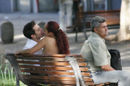 Our world and nothing else - couple kissing on a bench in Vale do Anhangabaú, a square in the centre of Sao Paulo