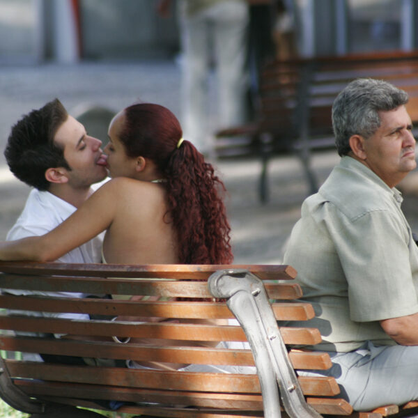 Our world and nothing else - couple kissing on a bench in Vale do Anhangabaú, a square in the centre of Sao Paulo